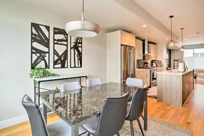 a dining room and kitchen with a table and chairs at City Skyline Views Upscale Denver Townhome in Denver