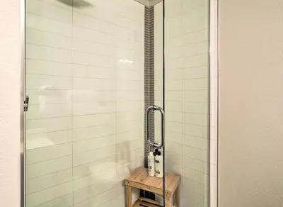 a bathroom with a shower with a glass door at City Skyline Views Upscale Denver Townhome in Denver