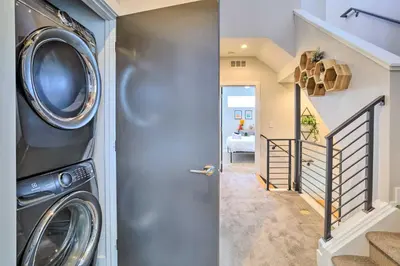 a hallway with a washer and dryer in a house at City Skyline Views Upscale Denver Townhome in Denver