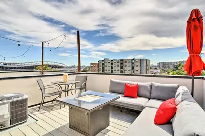 a living room with a couch and a table on a roof at City Skyline Views Upscale Denver Townhome in Denver