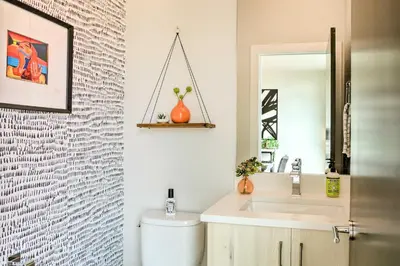a bathroom with a toilet and a sink and a mirror at City Skyline Views Upscale Denver Townhome in Denver