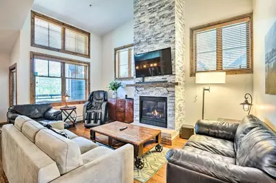 a living room with couches and a fireplace at Winter Park Condo with Mountain Views and Hot Tub in Winter Park