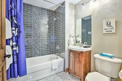 a bathroom with a tub and a toilet and a sink at Winter Park Condo with Mountain Views and Hot Tub in Winter Park