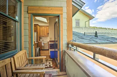 a porch with a bench on a house at Winter Park Condo with Mountain Views and Hot Tub in Winter Park