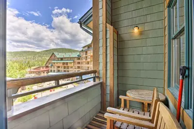 a porch with a table and a bench on a balcony at Winter Park Condo with Mountain Views and Hot Tub in Winter Park