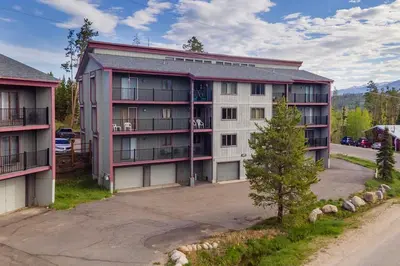 an apartment building with a tree in front of it at 10 min to Resort! Amazing Views & Sauna! in Winter Park