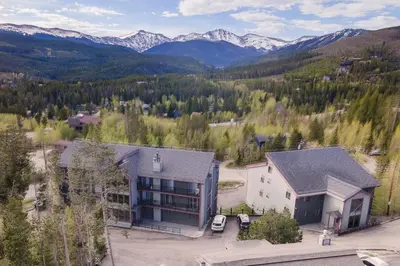 an aerial view of a building with mountains in the background at 10 min to Resort! Amazing Views & Sauna! in Winter Park