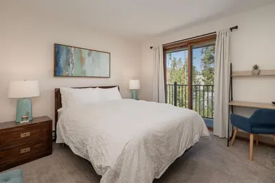 a bedroom with a large bed and a window at 10 min to Resort! Amazing Views & Sauna! in Winter Park