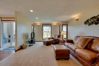 a living room with a leather couch and chairs at Loveland Townhome Walkable to Lake and Park! in Loveland