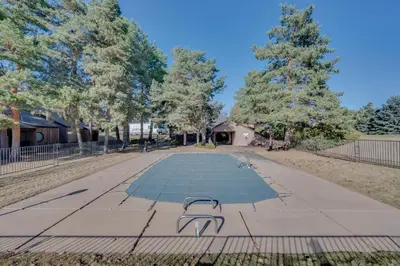 a park with a bench in the middle of a sidewalk at Loveland Townhome Walkable to Lake and Park! in Loveland