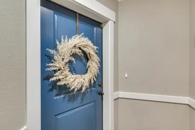 a blue door with a wreath on it at Elegant Loveland Condo Less Than 5 Mi to Old Town! in Loveland
