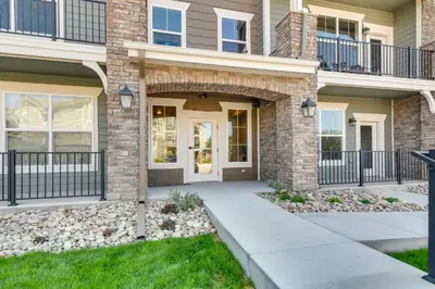 a brick house with a front door and a walkway at Elegant Loveland Condo Less Than 5 Mi to Old Town! in Loveland