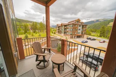 a balcony with a table and chairs and a view of a building at Clearwater Lofts Bldg 2 201 by SummitCove Lodging in Keystone