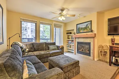 a living room with a couch and a fireplace at Charming Winter Park Condo - Steps to Slopes! in Winter Park