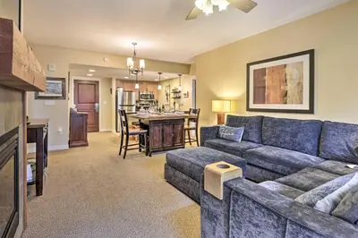 a living room with a couch and a table at Charming Winter Park Condo - Steps to Slopes! in Winter Park
