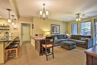 a kitchen and living room with a couch and a table at Charming Winter Park Condo - Steps to Slopes! in Winter Park