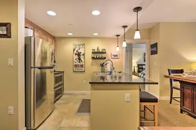 a kitchen with a sink and a refrigerator at Charming Winter Park Condo - Steps to Slopes! in Winter Park