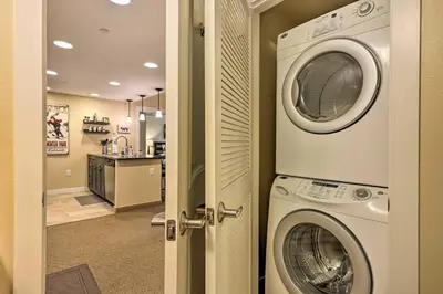 a laundry room with a washer and dryer at Charming Winter Park Condo - Steps to Slopes! in Winter Park