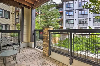 a balcony with a table and chairs and a building at Charming Winter Park Condo - Steps to Slopes! in Winter Park
