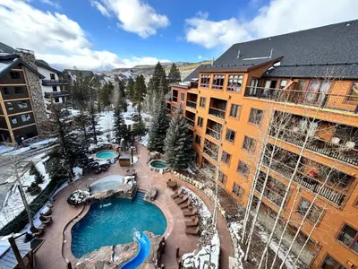 an aerial view of a resort with a swimming pool at Springs 8913 by SummitCove Lodging in Keystone
