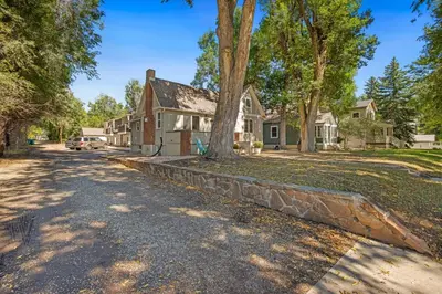 a house with a tree in the driveway at Elegant Old Town Charm - Walk to CSU and Downtown in Fort Collins