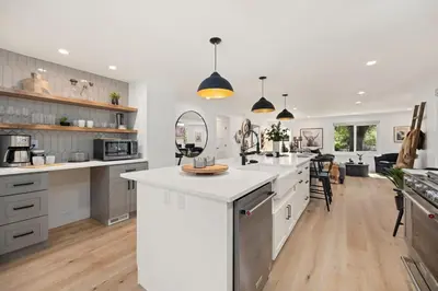 a kitchen with white cabinets and a white counter top at Elegant Old Town Charm - Walk to CSU and Downtown in Fort Collins