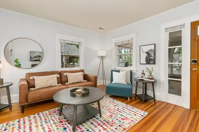 a living room with a couch and a table at Downtown Abode with Hot Tub - Walk to CSU & Old Town in Fort Collins