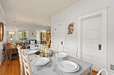 a white dining room with a table and chairs at Downtown Abode with Hot Tub - Walk to CSU & Old Town in Fort Collins