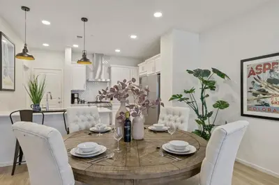 a dining room and kitchen with a table and chairs at NEW! Cozy Colorado Living - 8 min from Old Town! in Fort Collins