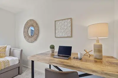 a desk with a laptop and a lamp on it at NEW! Cozy Colorado Living - 8 min from Old Town! in Fort Collins