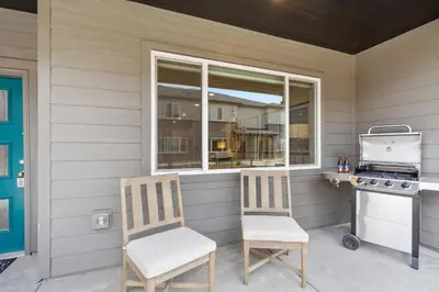 two chairs on a porch with a stove and a window at NEW! Cozy Colorado Living - 8 min from Old Town! in Fort Collins
