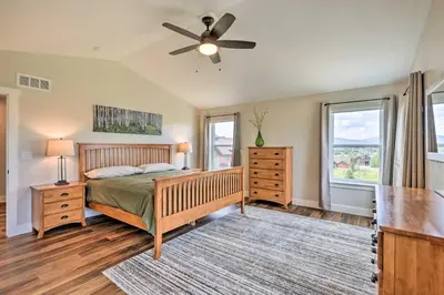 a bedroom with a bed and a ceiling fan at Walk To Golf Modern Mtn-View Home in Granby in Granby