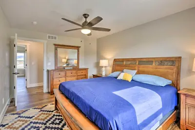 a bedroom with a blue bed and a ceiling fan at Walk To Golf Modern Mtn-View Home in Granby in Granby