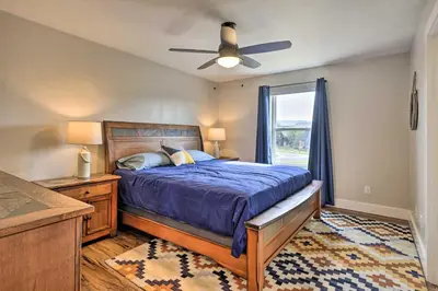 a bedroom with a bed and a ceiling fan at Walk To Golf Modern Mtn-View Home in Granby in Granby