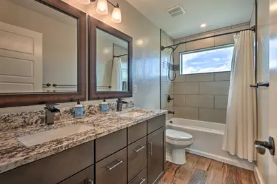 a bathroom with two sinks and a toilet and a tub at Walk To Golf Modern Mtn-View Home in Granby in Granby