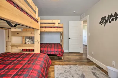 a bedroom with a bed and a bunk bed at Walk To Golf Modern Mtn-View Home in Granby in Granby