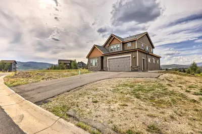 a large house on a hill with a driveway at Walk To Golf Modern Mtn-View Home in Granby in Granby