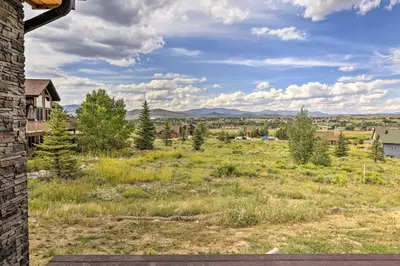 a view of a field with trees and buildings at Walk To Golf Modern Mtn-View Home in Granby in Granby