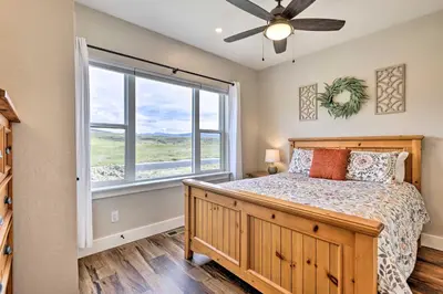 a bedroom with a bed and a window at Walk To Golf Modern Mtn-View Home in Granby in Granby