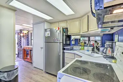 a kitchen with a refrigerator and a sink at 6 Mi to Ski Resort! Lakefront Breckenridge Cabin in Breckenridge