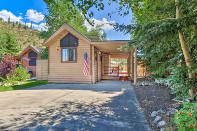 a house with a flag in front of it at 6 Mi to Ski Resort! Lakefront Breckenridge Cabin in Breckenridge