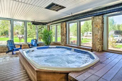 a jacuzzi tub in a room with windows at 6 Mi to Ski Resort! Lakefront Breckenridge Cabin in Breckenridge