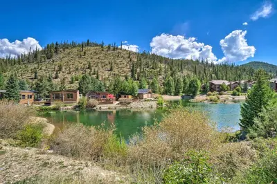 a resort with a river in front of a mountain at 6 Mi to Ski Resort! Lakefront Breckenridge Cabin in Breckenridge
