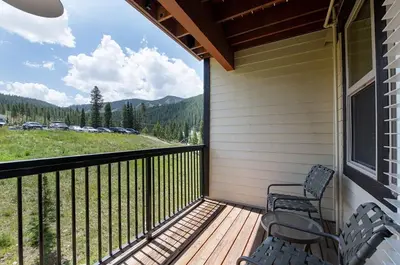 a porch with two chairs and a view of the mountains at Winter Park FF Premium-Rated 4470 in Winter Park