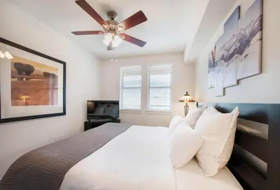 a bedroom with a bed with a ceiling fan at Winter Park FF Premium-Rated 4470 in Winter Park