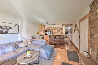 a living room with a couch and a table at Cozy and Chic Mountain Condo with Community Perks in Fraser