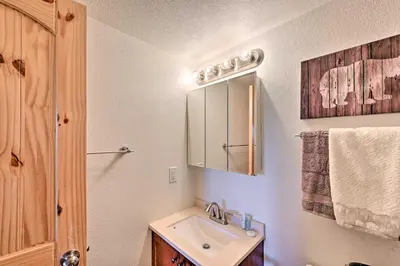 a bathroom with a sink and a mirror at Cozy and Chic Mountain Condo with Community Perks in Fraser