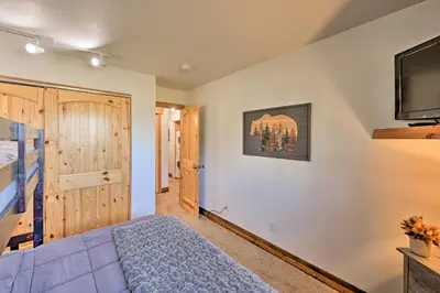 a bedroom with a bed and a flat screen tv at Cozy and Chic Mountain Condo with Community Perks in Fraser