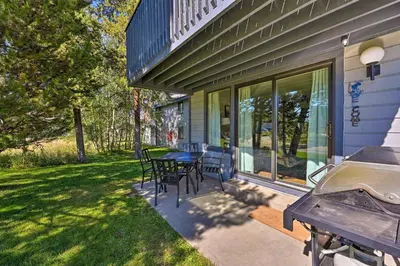a patio with a table and chairs and a grill at Cozy and Chic Mountain Condo with Community Perks in Fraser