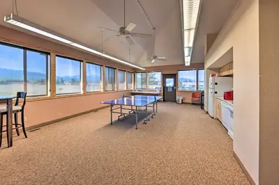 an office with a table and a kitchen with windows at Cozy and Chic Mountain Condo with Community Perks in Fraser